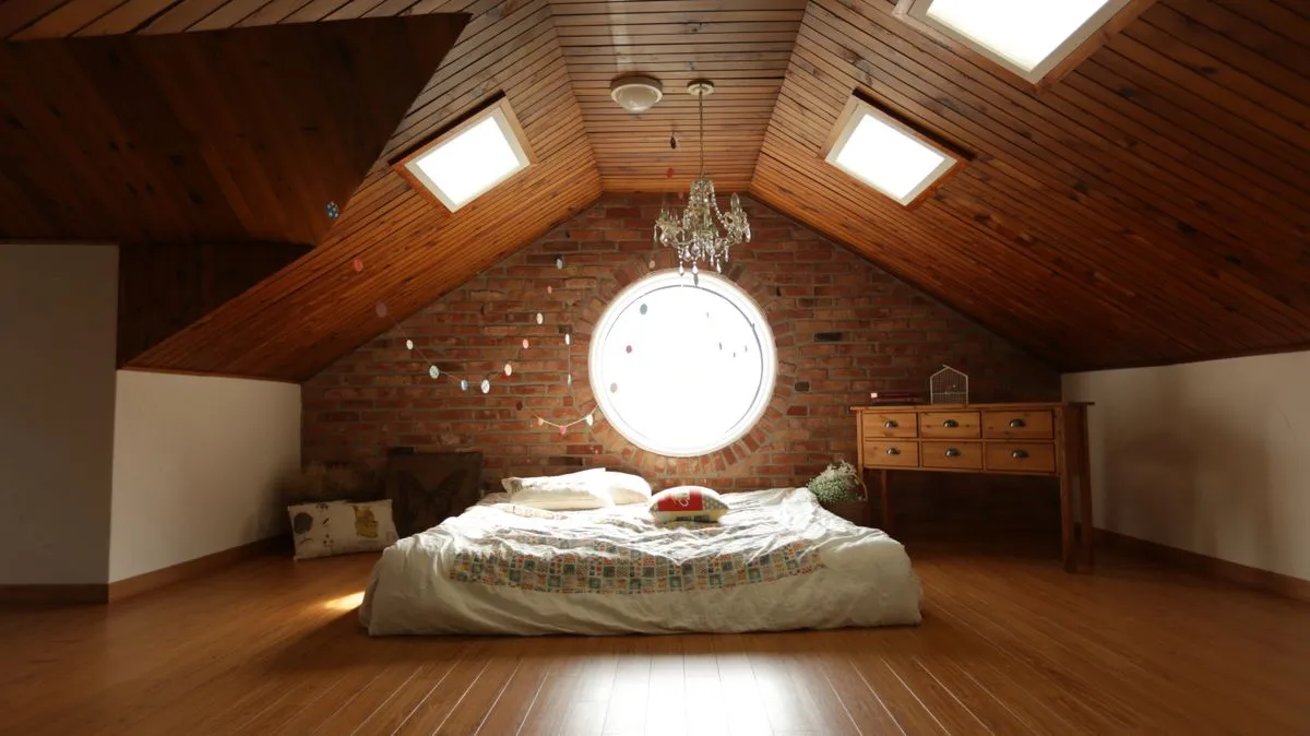 Attic bedroom featuring a round specialty window and wood-framed skylights