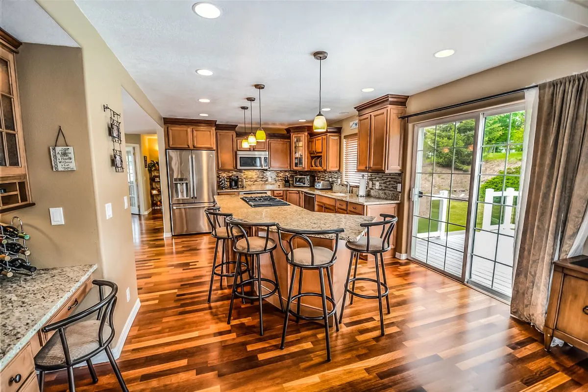 Kitchen opening onto the backyard through new sliding glass patio doors