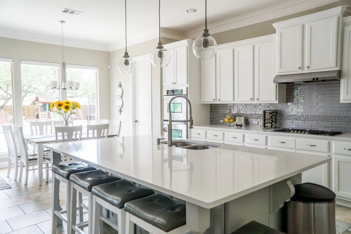 White-framed windows filling a bright kitchen and dining area with daylight