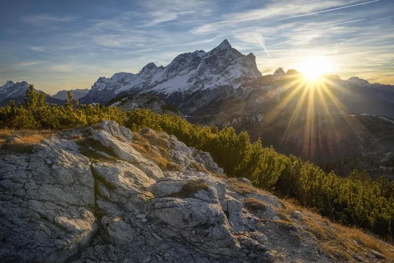 Snow-covered mountain peaks in low winter sun